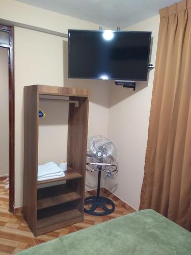 a room with a fan and a flat screen tv at D' Barrig in Trujillo