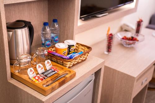 a kitchen counter with a basket of food and water bottles at Nairoukh Hotel Aqaba in Aqaba