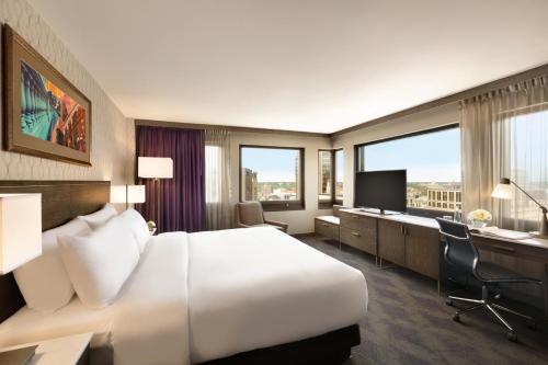 a hotel room with a large bed and a desk at InterContinental St. Paul Riverfront by IHG in Saint Paul
