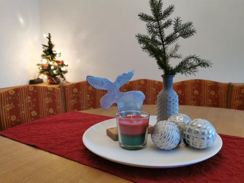 a plate with a drink and christmas decorations on a table at appartementen Haus Bergblick in Gosau
