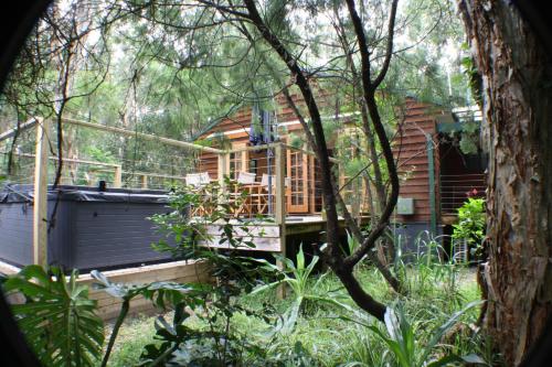 a tree house in the middle of a garden at Wanderers Retreat in Nelson Bay