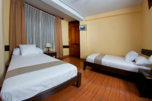 Postel nebo postele na pokoji v ubytování Yucay Plaza Inn