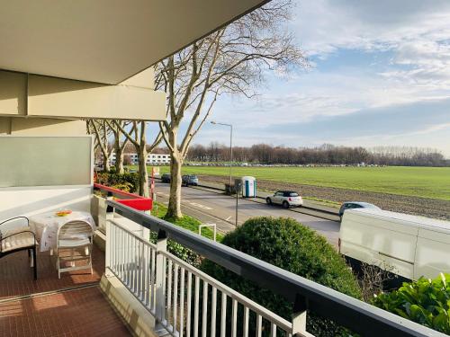 a balcony of a house with a view of a highway at Messe Apartment Köln West in Cologne