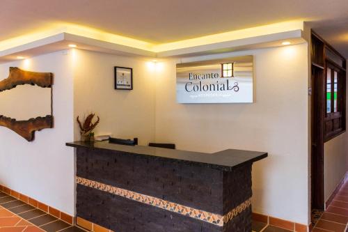 a lobby with a sign for the entrance to a dental office at HOTEL ENCANTO COLONIAL in Villa de Leyva