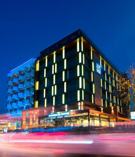 a hotel building with lights on in the night at Ilayda Avantgarde Hotel in Kusadası