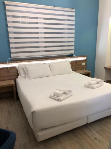 a large bed in a room with a large window at B&B Villa S.Anna in Bari