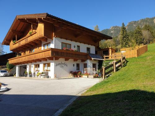 a house with a balcony on top of it at Hanslerfeld in Alpbach