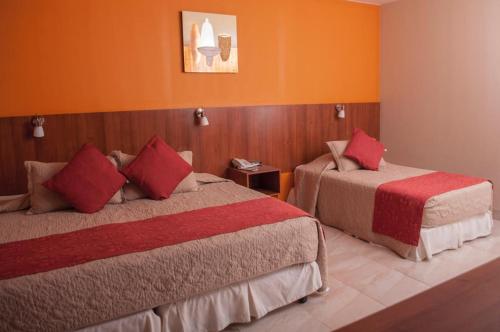 Giường trong phòng chung tại Hotel Mitru - Tarija