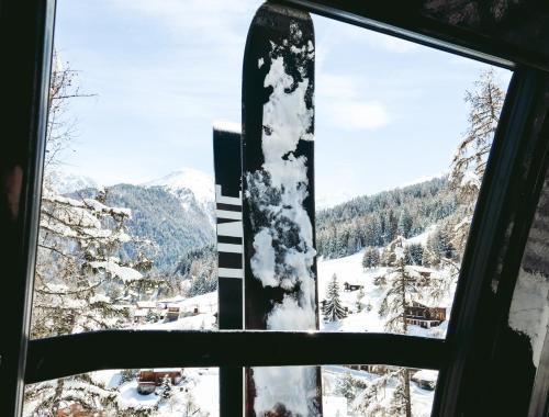 a window with a view of a snow covered mountain at Hôtel Chalet Royal in Veysonnaz
