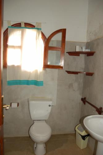 a bathroom with a toilet and a sink at JoysVilla Family Holiday Home in Malindi