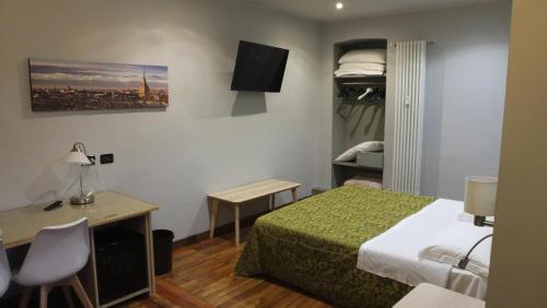a hotel room with a bed and a desk and a desk at Artua'&Solferino in Turin