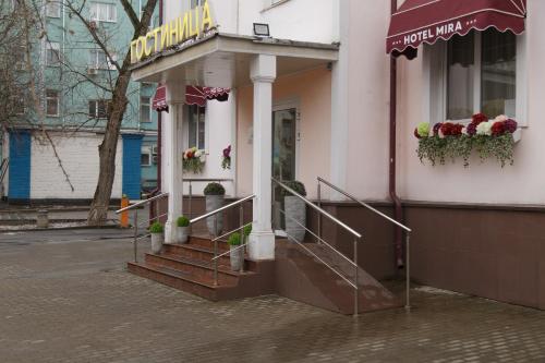 a building with stairs in front of a store at Mira Hotel in Moscow