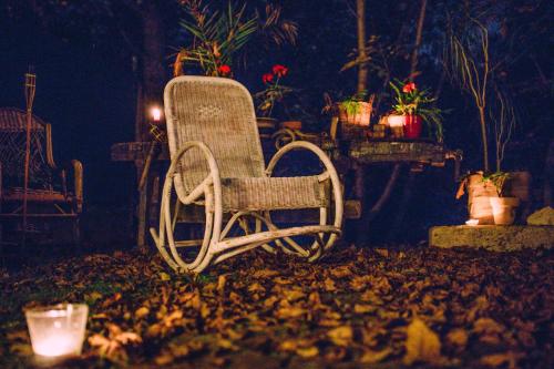 a wicker chair sitting in a yard at night at Vila Terrasse in Košice