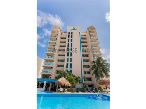 a view of the hotel from the pool at 2 Story Oceanfront Penthouses on Cancun Beach! in Cancún