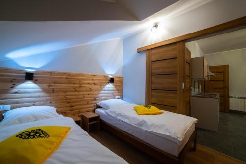 a bedroom with two beds in a room at Apartamenty Słoneczny Przystanek in Szczyrk