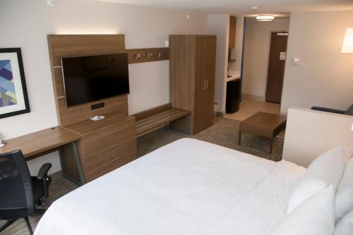 a hotel room with a bed and a flat screen tv at Holiday Inn Express & Suites Colorado Springs North by IHG in Colorado Springs