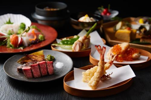 a group of plates of food on a table at ONSEN RYOKAN YUEN SHINJUKU in Tokyo