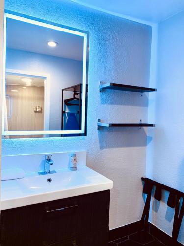 a bathroom with a sink and a mirror at Sakura Inn in Glendale