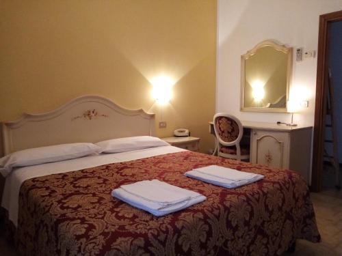 Кровать или кровати в номере Hotel Gasperoni