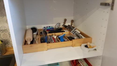 a wooden drawer filled with lots of utensils at Die kleine Karthause in Konz