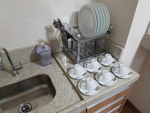 a kitchen counter with a sink and a mirror at Condomínio Vista azul in Domingos Martins