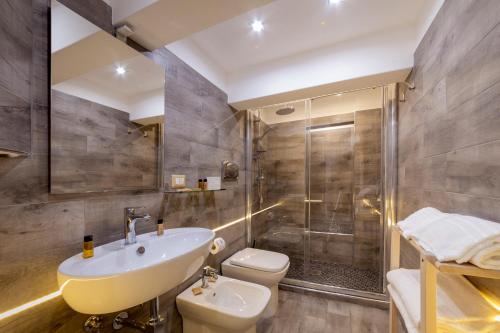 a bathroom with a sink toilet and a shower at B&B Palazzo Satriano in Naples