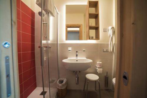 a small bathroom with a sink and a shower at Hotel Terme in Bormio
