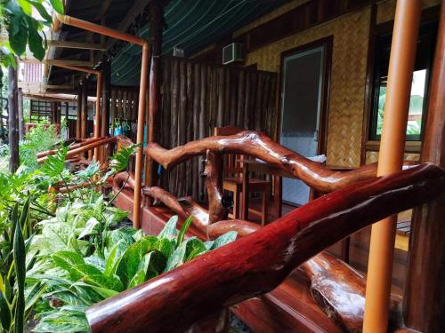 a wooden spiral staircase in a wooden house at BING-VICE Tourist Inn in San Vicente