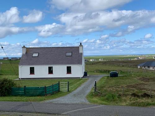 a white house on the side of a road at 18 Cross Skigesrta Road in Swanibost
