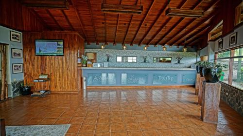 a very nice looking room with a lot of windows at El Establo Mountain Hotel in Monteverde Costa Rica