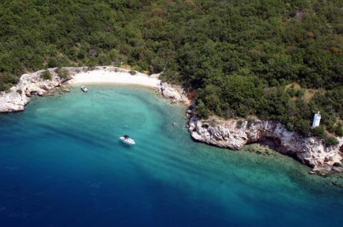 an aerial view of a beach with a boat in the water at Apartment Vincent with beautiful sea view terrace in Klenovica