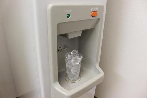 a refrigerator with a trash can inside of it at Hotel Hokke Club Hakodate in Hakodate