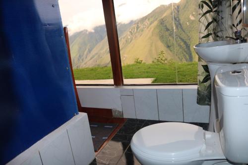 a bathroom with a toilet and a view of a mountain at Llactapata Lodge overlooking Machu Picchu - camping - restaurant in Salcantay