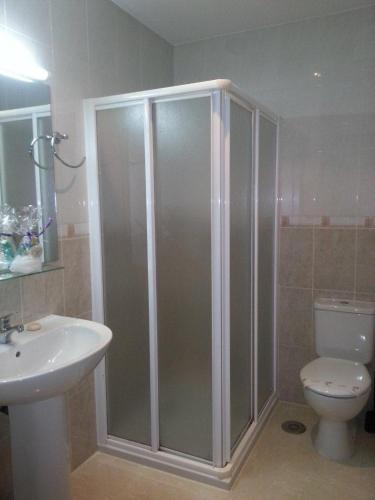 a bathroom with a shower and a toilet and a sink at Hostal Ancla Dorada in Vigo