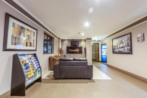 a living room with a couch and a tv at Super 8 by Wyndham Kamloops On The Hill in Kamloops