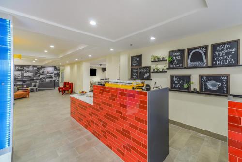 a fast food restaurant with a red brick wall at Saint Louis Airport Hotel in Saint Louis