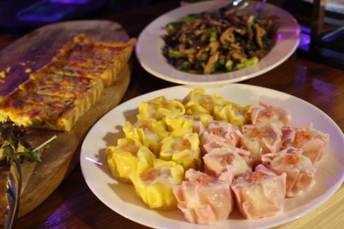 three plates of food on a wooden table at MARINE-Q in Inami