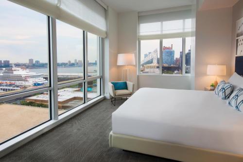 
a hotel room with a bed and a window at Ink 48 Hotel in New York
