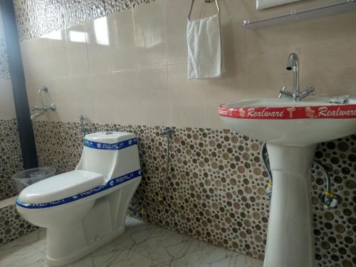 a bathroom with a toilet and a sink at Oxygen Homestay-A Blissful Retreat in Dehradun