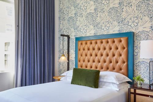 a bedroom with a bed with a blue and white wall at Kimpton Hotel Monaco Denver by IHG in Denver