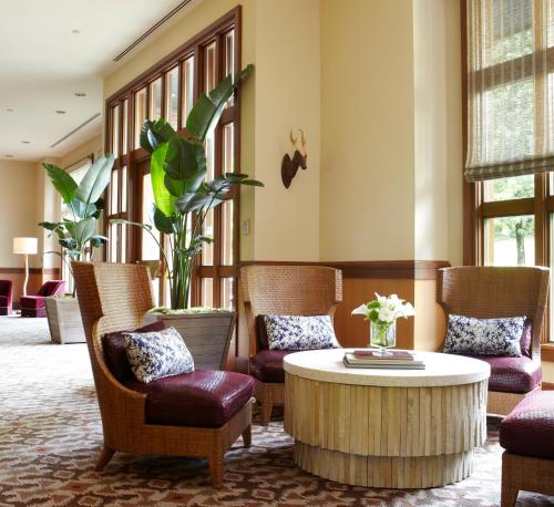 a living room filled with furniture and a large window at Kimpton Riverplace Hotel, an IHG Hotel in Portland