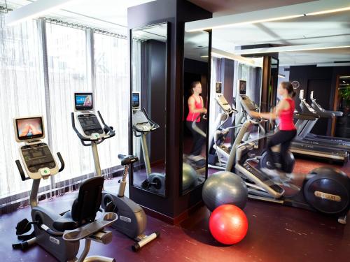 a gym with several people exercising on tread machines at Kimpton Hotel Eventi, an IHG Hotel in New York