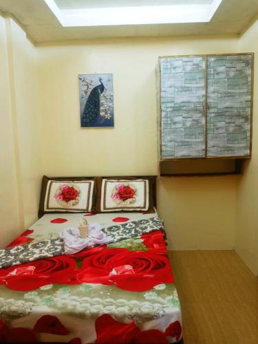 a bedroom with a bed with three pictures on the wall at Aquing's Place in El Nido