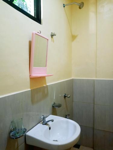 a bathroom with a sink and a mirror on the wall at Aquing's Place in El Nido