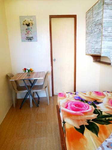 a room with a table and a bed and a dining room at Aquing's Place in El Nido