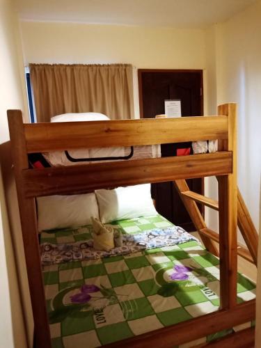 a bunk bed in a small room with a bed sidx sidx sidx at Aquing's Place in El Nido