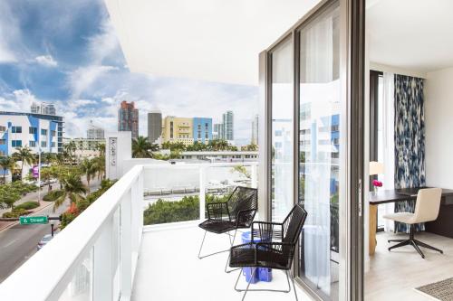 a living room with a large window overlooking a city at Kimpton Angler’s Hotel South Beach, an IHG Hotel in Miami Beach