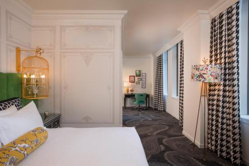 a bedroom with a bed and a desk in a room at Kimpton Hotel Monaco Pittsburgh by IHG in Pittsburgh