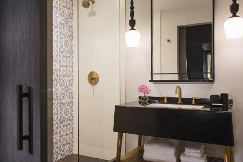 a bathroom with a sink and a mirror at Kimpton Gray Hotel Chicago by IHG in Chicago