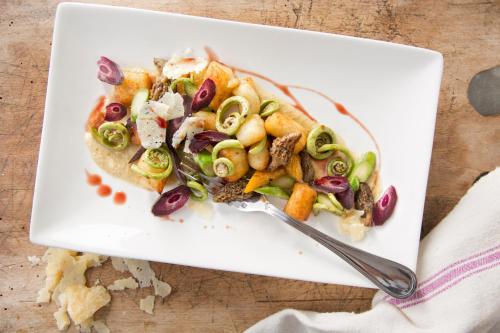 a plate of food with a salad on a table at Kimpton Brice Hotel by IHG in Savannah